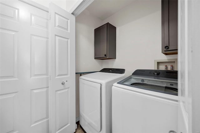 laundry area with cabinets and washer and clothes dryer