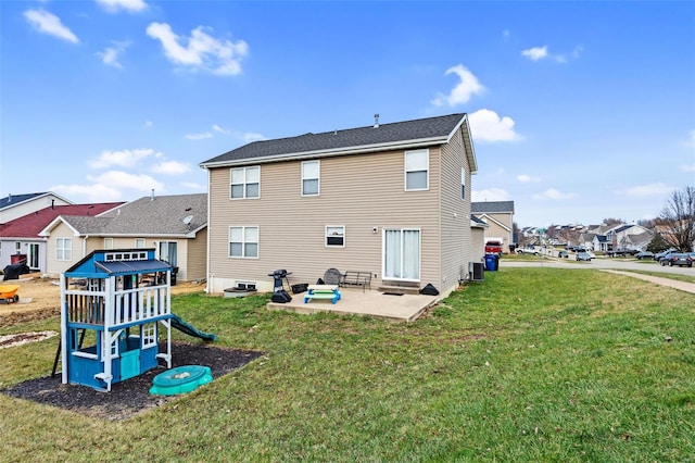 back of house featuring a patio, a playground, and a lawn