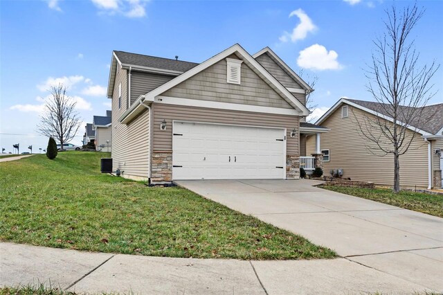 view of front of home with a front lawn and a garage