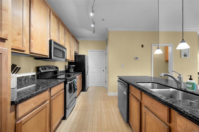 kitchen with crown molding, sink, dark stone counters, and stainless steel appliances