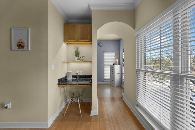 interior space with crown molding and light hardwood / wood-style floors