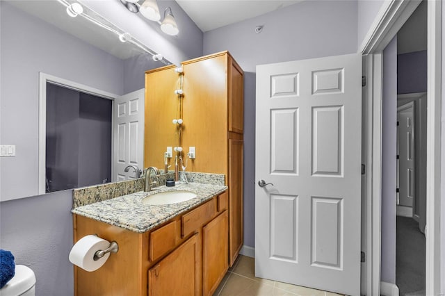 bathroom with vanity, toilet, and tile patterned flooring