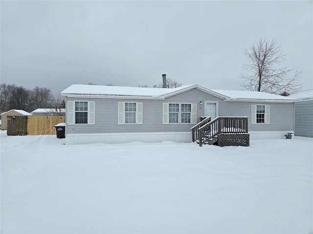 view of snow covered rear of property