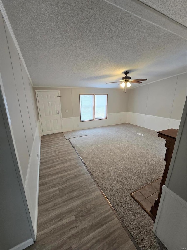 interior space with hardwood / wood-style floors, ceiling fan, and a textured ceiling