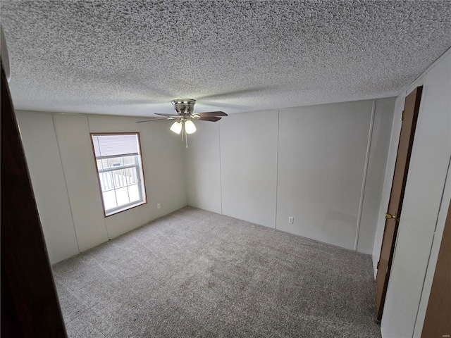 empty room with ceiling fan and carpet floors