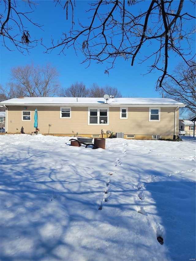 snow covered rear of property with cooling unit