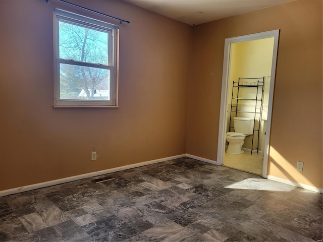 unfurnished bedroom featuring connected bathroom