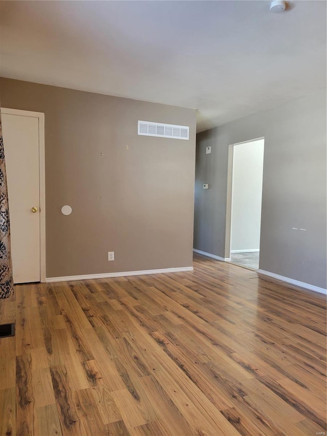 unfurnished room with light wood-type flooring