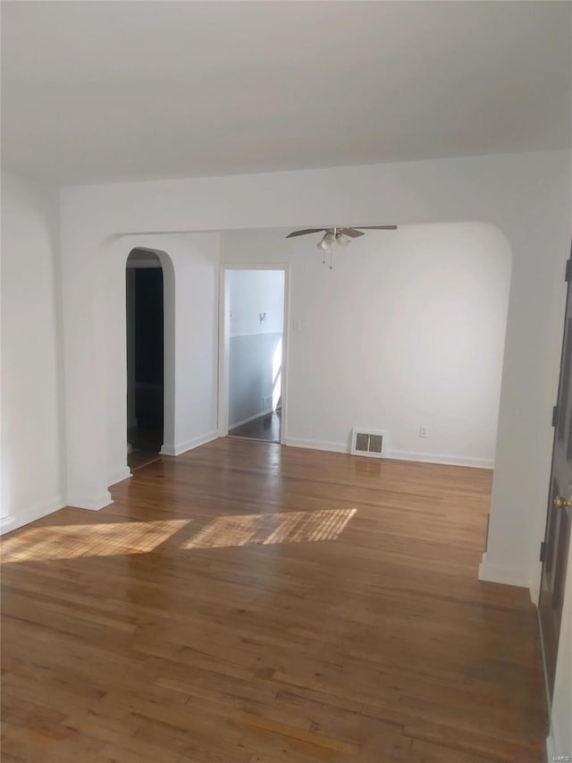 spare room with ceiling fan and dark hardwood / wood-style floors