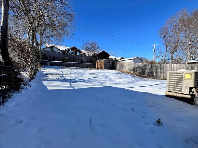 yard covered in snow with cooling unit