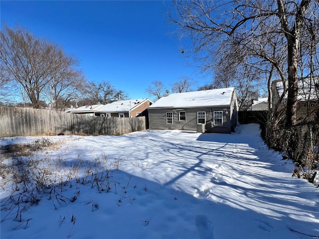 view of snow covered back of property