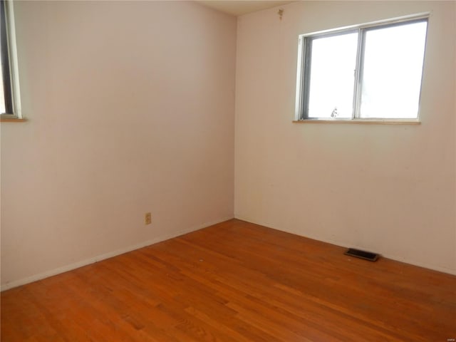 spare room with hardwood / wood-style floors