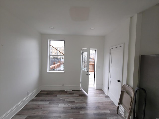 empty room with dark wood-type flooring