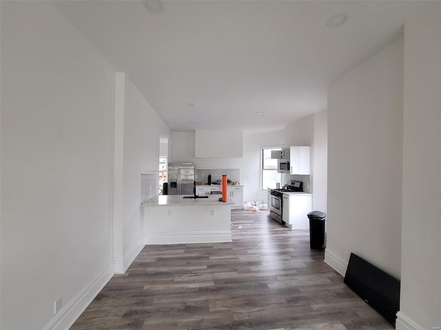 unfurnished living room with dark hardwood / wood-style floors