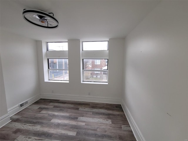 unfurnished room featuring dark hardwood / wood-style flooring