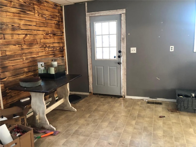 doorway featuring wooden walls