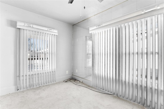 carpeted spare room with ceiling fan and radiator heating unit