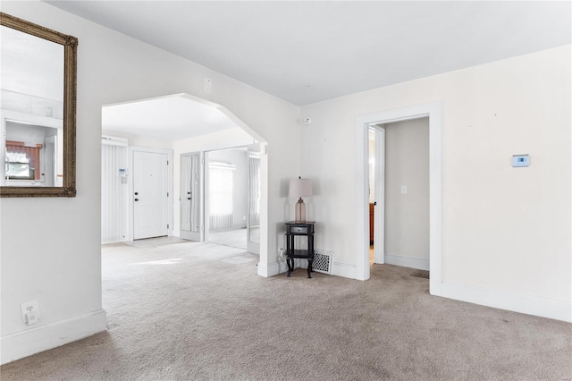 unfurnished room featuring light colored carpet