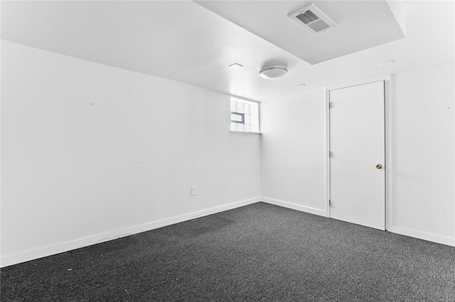 unfurnished room with dark colored carpet