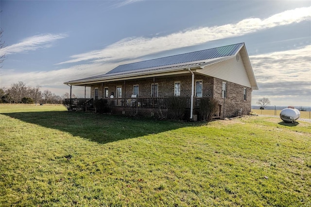 view of side of property featuring a yard and a porch