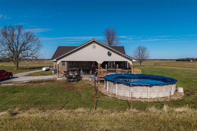 exterior space featuring a yard, a rural view, and a deck