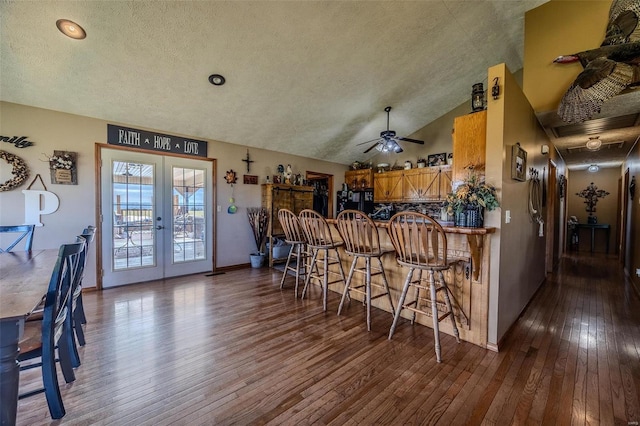 kitchen with french doors, dark hardwood / wood-style floors, ceiling fan, and lofted ceiling