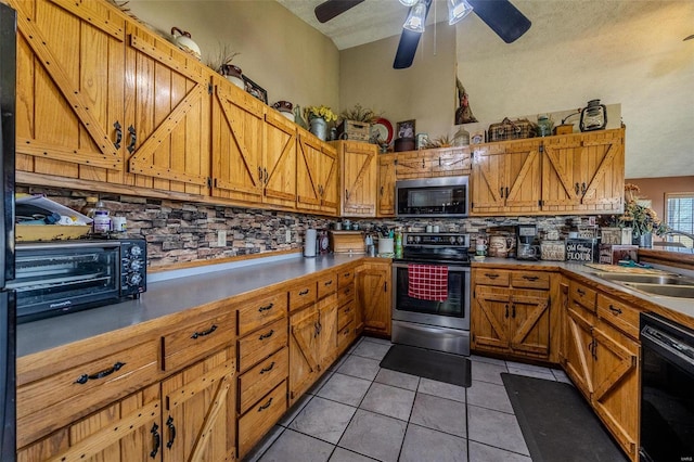 kitchen with sink, a textured ceiling, decorative backsplash, light tile patterned floors, and appliances with stainless steel finishes