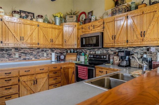 kitchen with decorative backsplash, sink, and appliances with stainless steel finishes