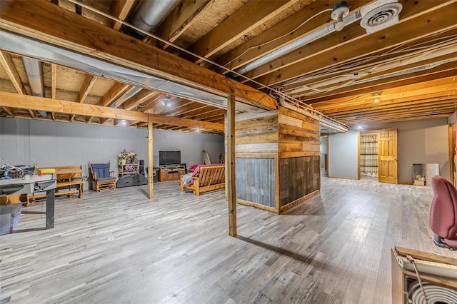 basement with hardwood / wood-style floors