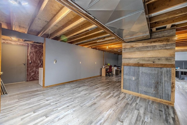 basement with hardwood / wood-style flooring