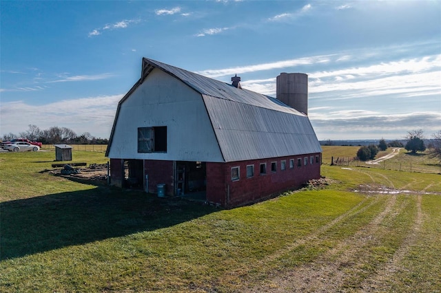 view of outdoor structure featuring a yard and a rural view