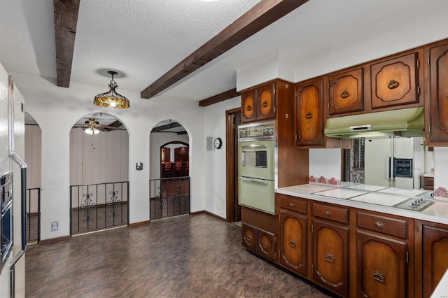 kitchen with a textured ceiling, white appliances, ceiling fan, pendant lighting, and beam ceiling