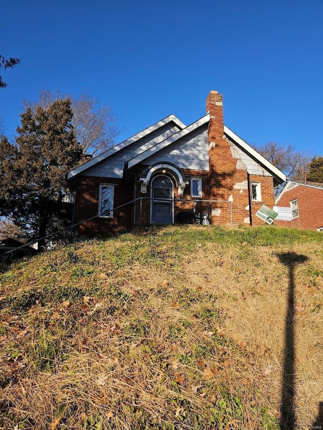 back of property featuring a yard