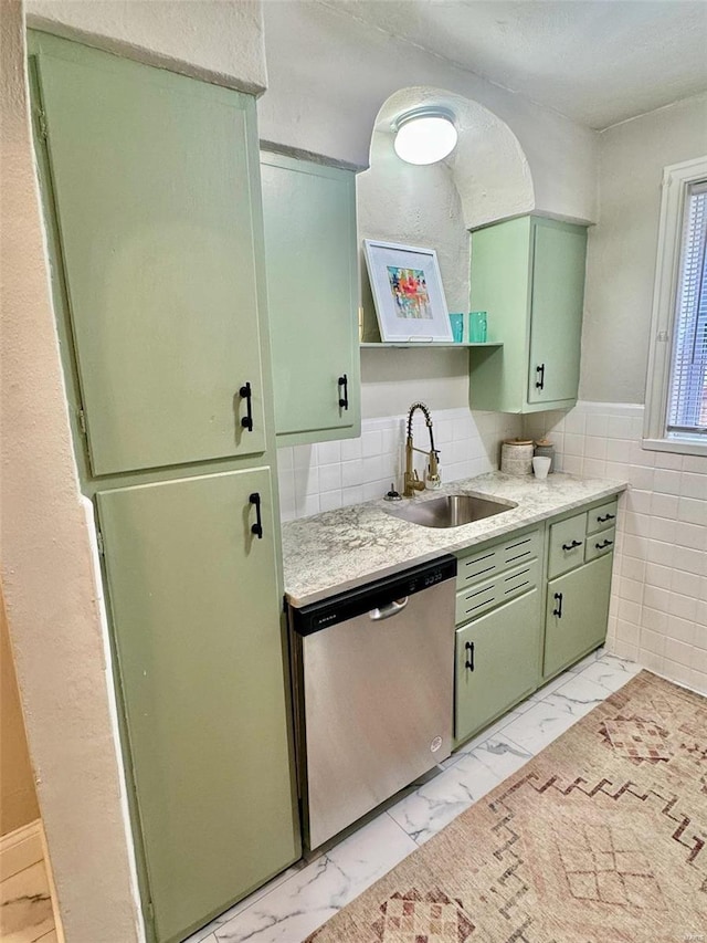 kitchen with green cabinets, dishwasher, and sink