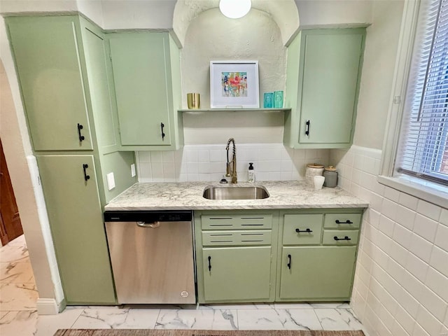 kitchen featuring green cabinets, light stone countertops, dishwasher, and sink