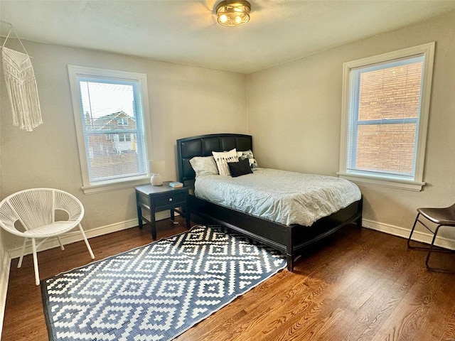 bedroom with dark hardwood / wood-style floors