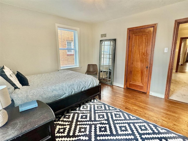 bedroom with hardwood / wood-style floors