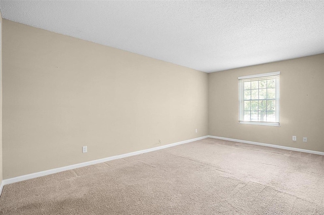 carpeted spare room featuring a textured ceiling