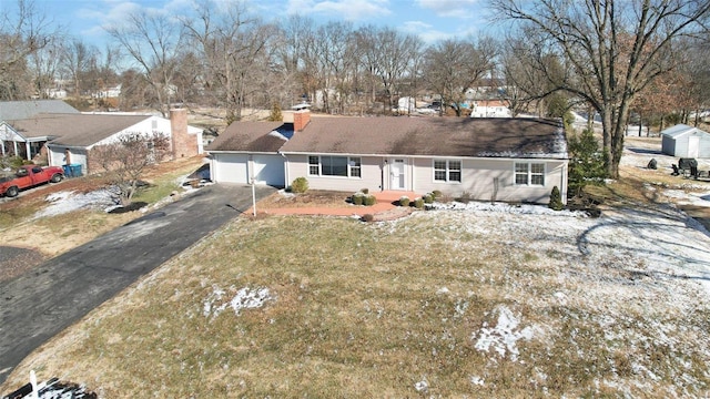 view of front of home featuring a garage and a front lawn