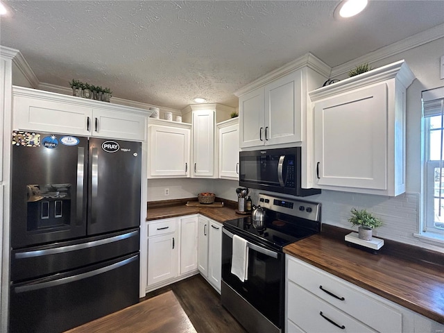 kitchen featuring white cabinetry, black fridge, and stainless steel range with electric stovetop