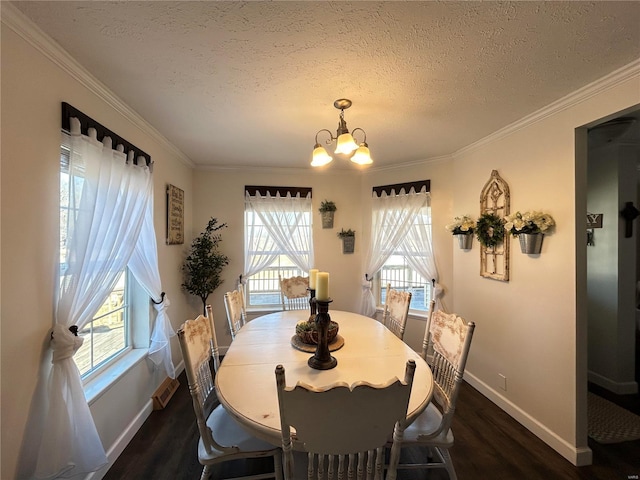 dining area featuring a textured ceiling, ornamental molding, dark hardwood / wood-style floors, and a chandelier