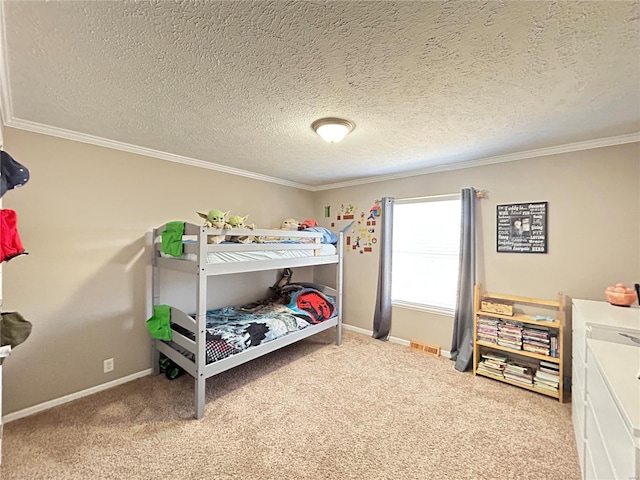 bedroom with crown molding, carpet, and a textured ceiling