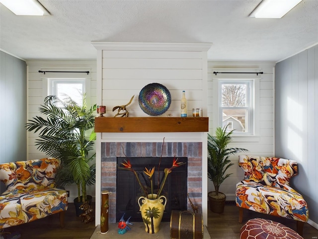 interior space with a brick fireplace, a healthy amount of sunlight, and crown molding