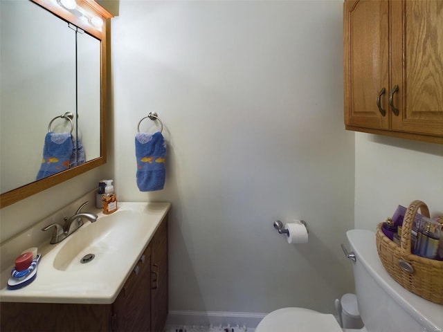 bathroom featuring toilet and vanity