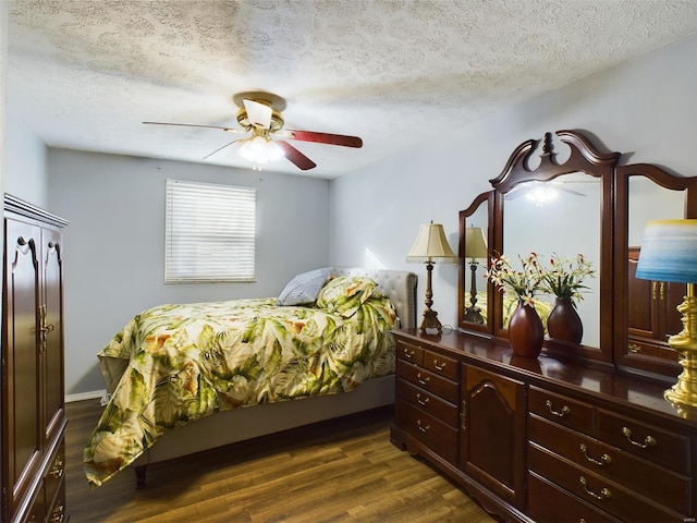 bedroom featuring ceiling fan, dark wood-type flooring, and a textured ceiling