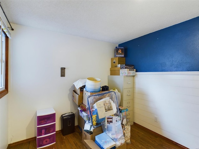 bedroom with dark hardwood / wood-style flooring and a textured ceiling