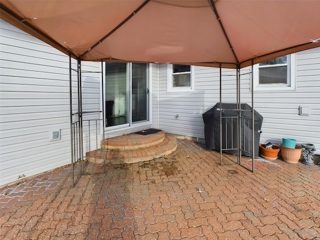 view of patio / terrace featuring a gazebo and a grill