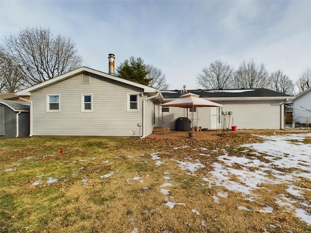 back of house with a gazebo and a yard