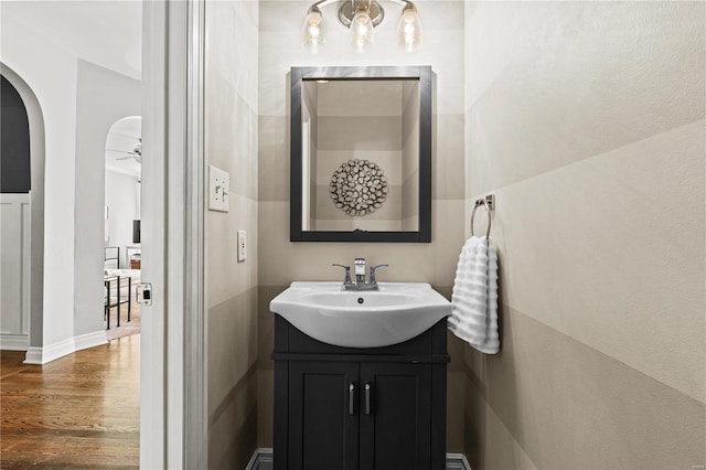 bathroom featuring ceiling fan, hardwood / wood-style floors, and vanity