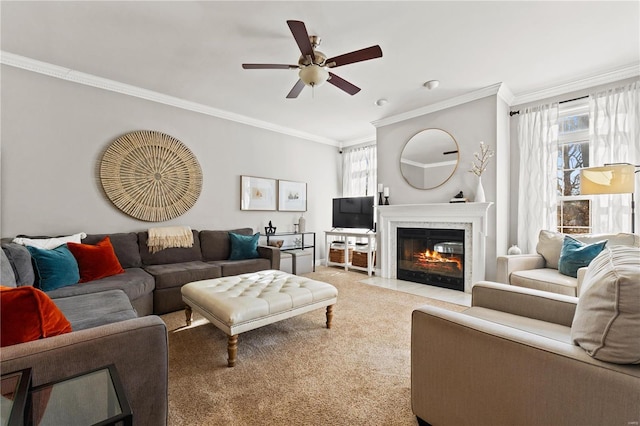 living room with ornamental molding, ceiling fan, and carpet